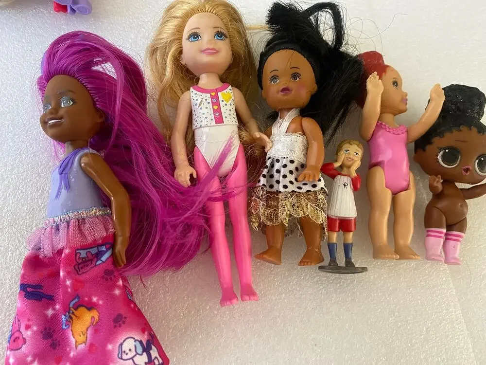 group of small Barbie Club Chelsea dolls and miniature figures in mixed outfits